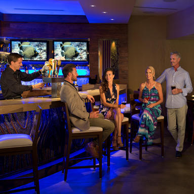 two couples sitting down at the bar in costa d'este