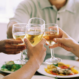 four people toasting with champagne at costa d'este