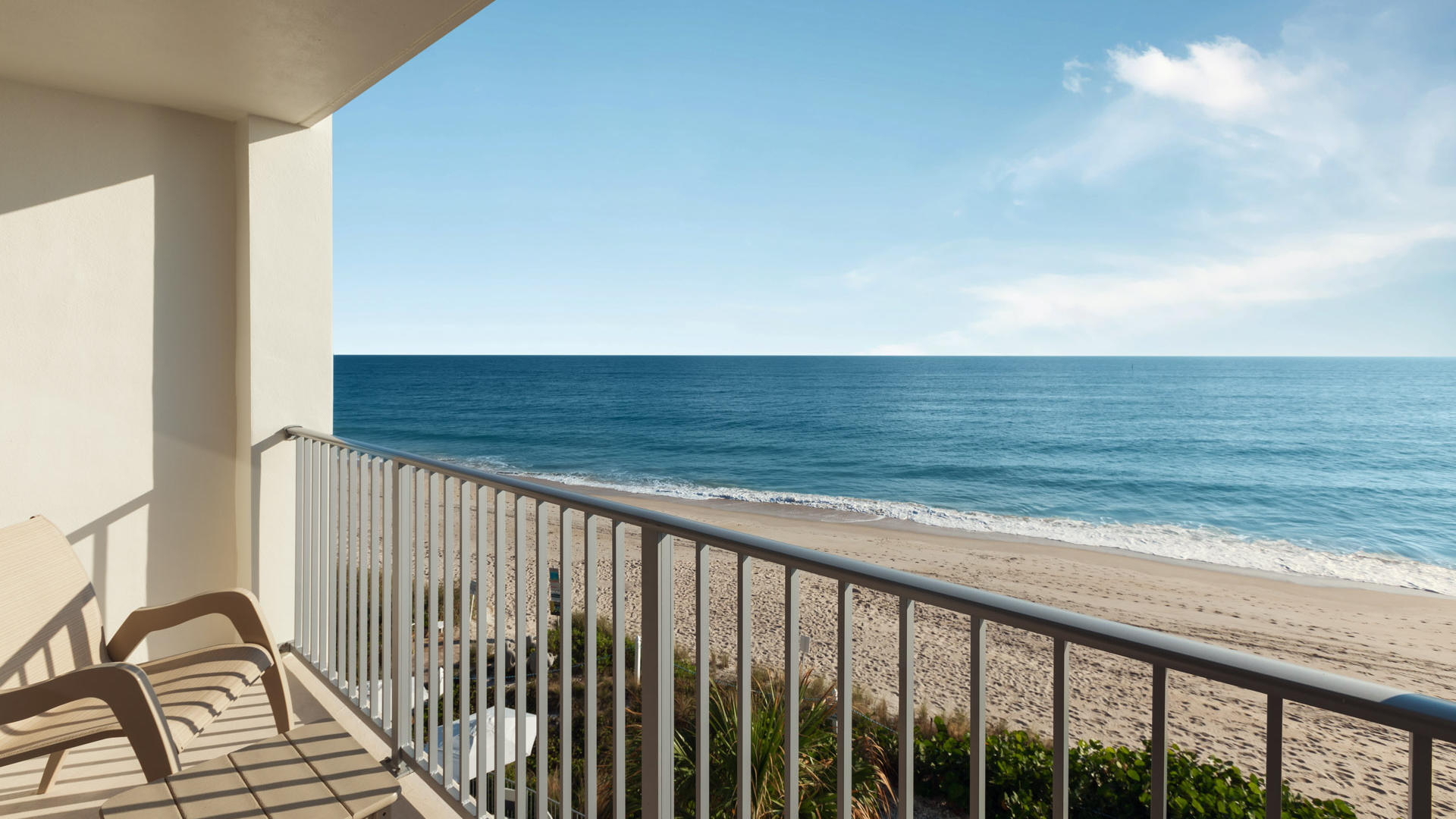 two chairs on a patio overlooking the ocean on vero beach