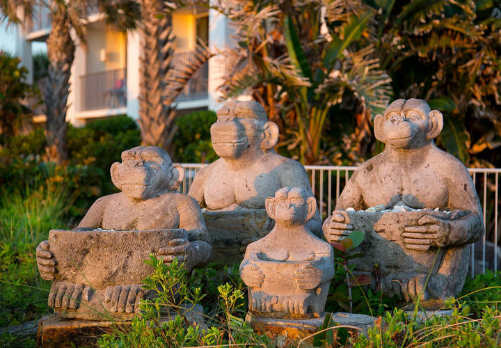 costa monkey statues holding seashells