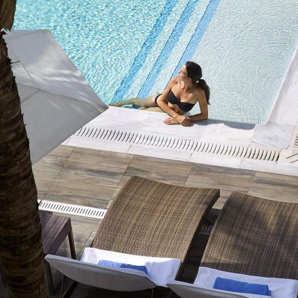 woman lounging in the pool at costa d'este