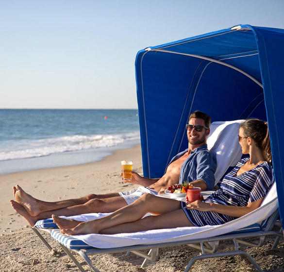 A couple lounging on the beach