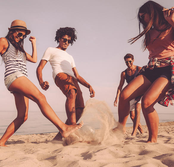 People playing in the sand on beach