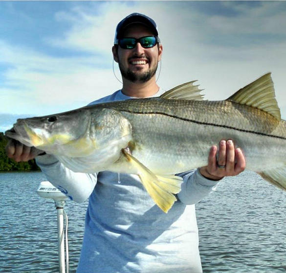 Man holding a fish he caught