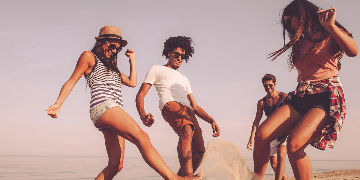 Friends playing in the sand on the beach